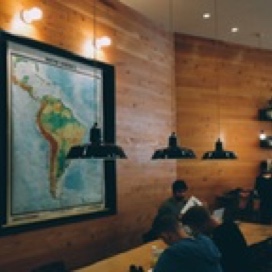 cozy campus setting, students sitting at table